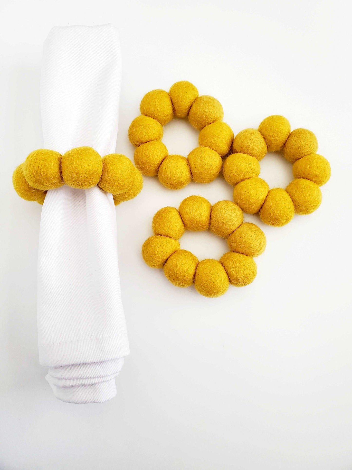 This Global Groove Life, handmade, ethical, fair trade, eco-friendly, sustainable, felt Mustard Napkin Ring set was created by artisans in Kathmandu Nepal and will bring colorful warmth and functionality to your table top.
