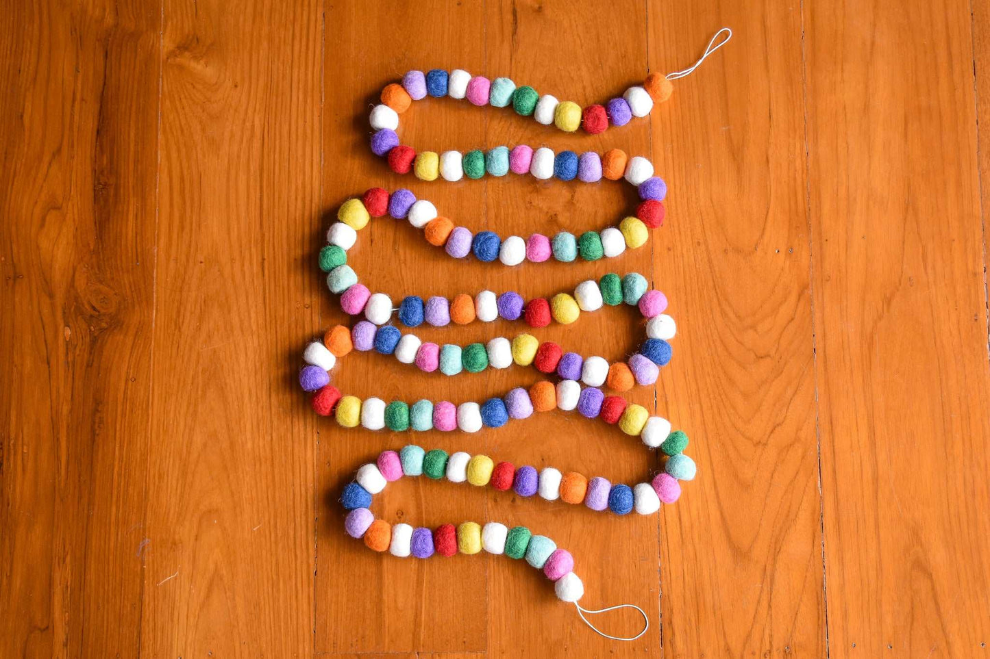 This Global Groove Life, handmade, ethical, fair trade, eco-friendly, sustainable, felt, red, white, pink, green, blue, purple, and orange felt Gumdrop garland ,was created by artisans in Kathmandu Nepal and will bring beautiful color, warmth and fun to your home.