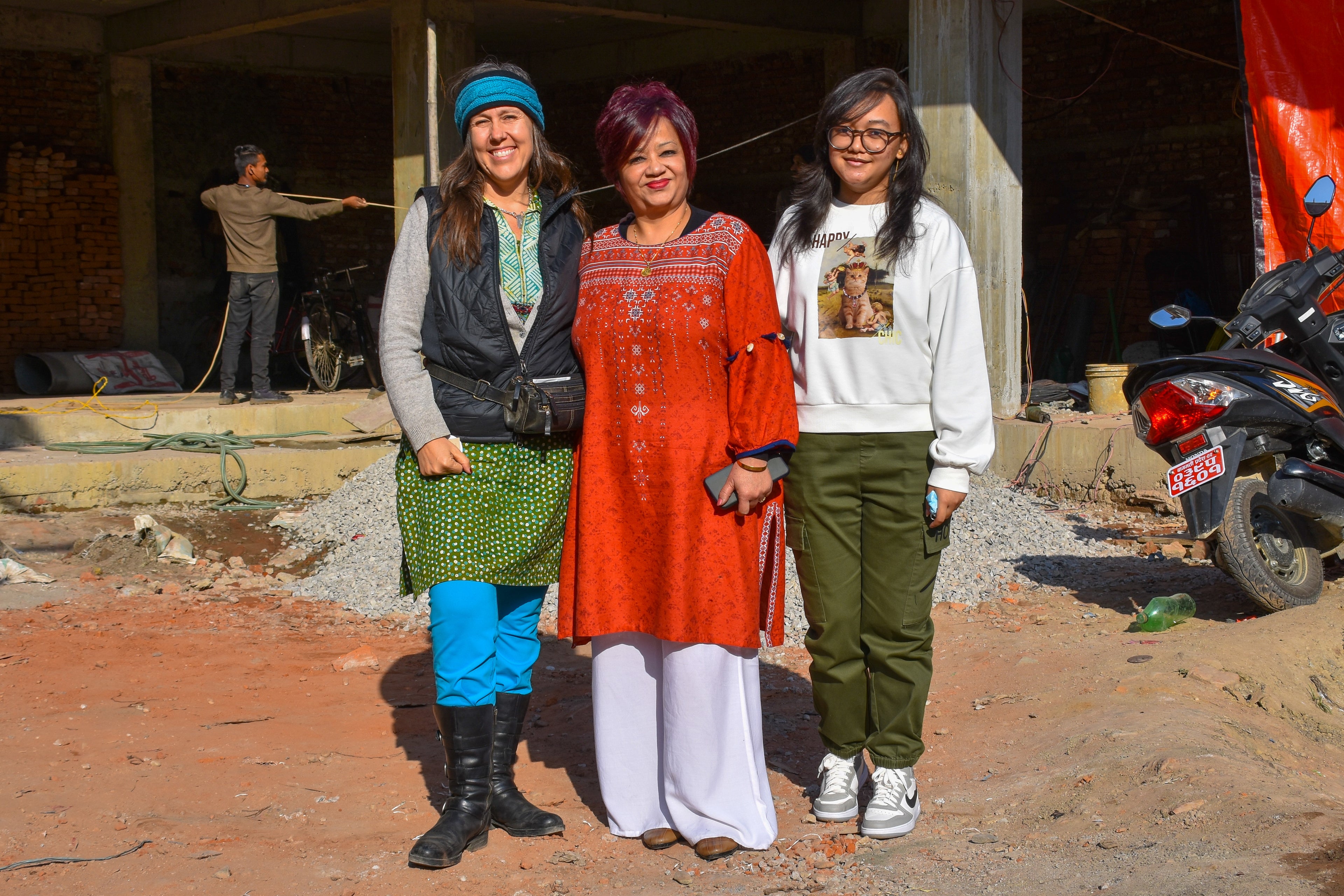 Our artisans are based in Nepal. This is a picture of us and them in the fabric.