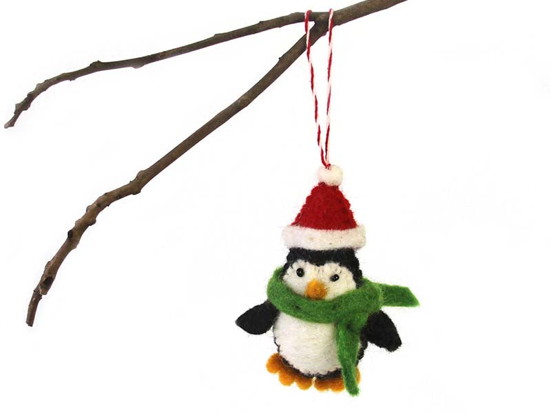 This Global Groove Life, handmade, ethical, fair trade, eco-friendly, sustainable, black and white penguin with Santa hat ornament was created by artisans in Kathmandu Nepal and will be a beautiful addition to your Christmas tree this holiday season.