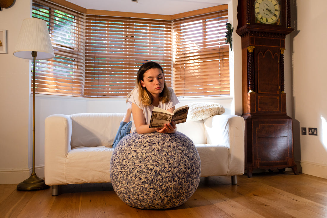 The yoga ball is perfect to be comfortable while reading on a coach