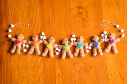 This Global Groove Life, handmade, ethical, fair trade, eco-friendly, sustainable, gingerbread friends felt garland with red, orange, yellow, green, blue and purple heart motif ,was created by artisans in Kathmandu Nepal and will bring beautiful color, warmth and fun to your home.