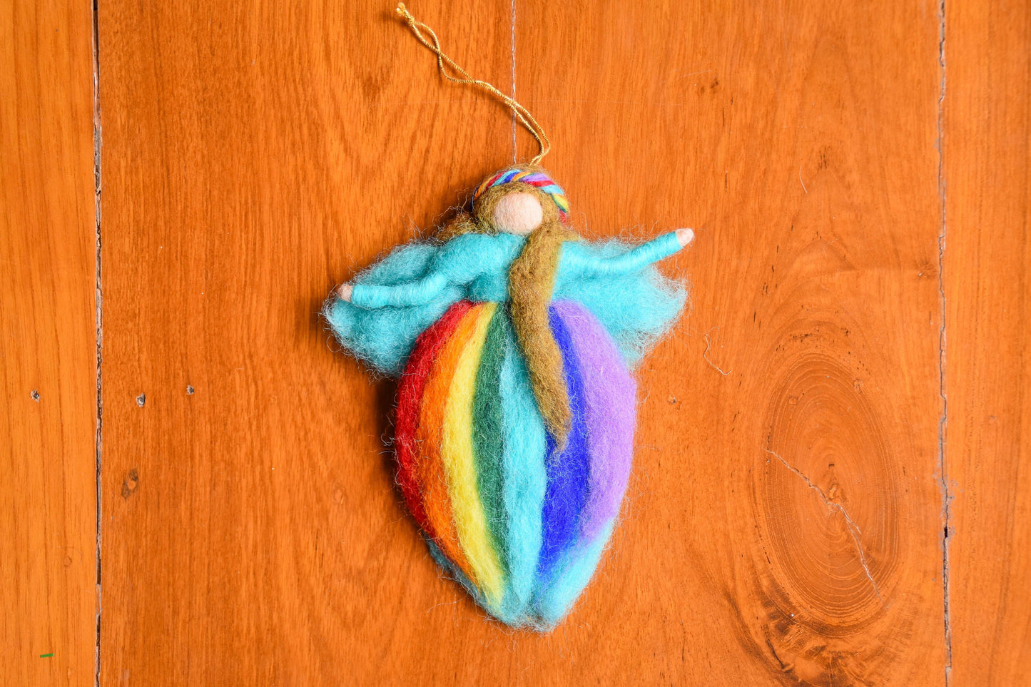 This Global Groove Life, handmade, ethical, fair trade, eco-friendly, sustainable, blue felt, rainbow angel fairy ornament, was created by artisans in Kathmandu Nepal and will be a beautiful addition to your Christmas tree this holiday season.
