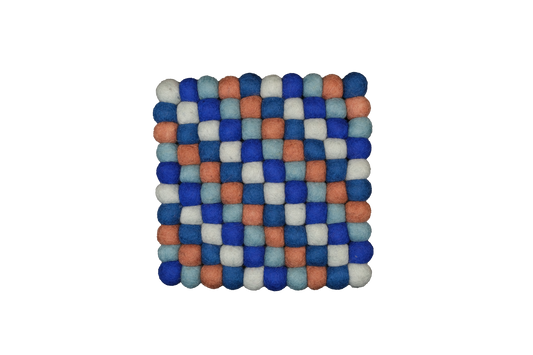 This Global Groove Life, handmade, ethical, fair trade, eco-friendly, sustainable, terra-cotta /clay, blue & white 100% New Zealand wool felt trivet was created by artisans in Kathmandu Nepal and will bring colorful warmth and functionality to your table top.