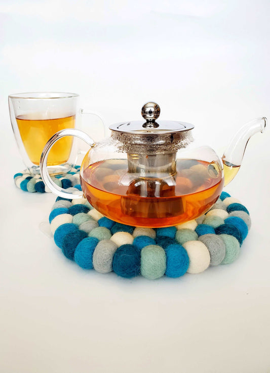 This Global Groove Life, handmade, ethical, fair trade, eco-friendly, sustainable, blue, grey and white felt Glacier trivet was created by artisans in Kathmandu Nepal and will bring warmth and functionality to your table top.