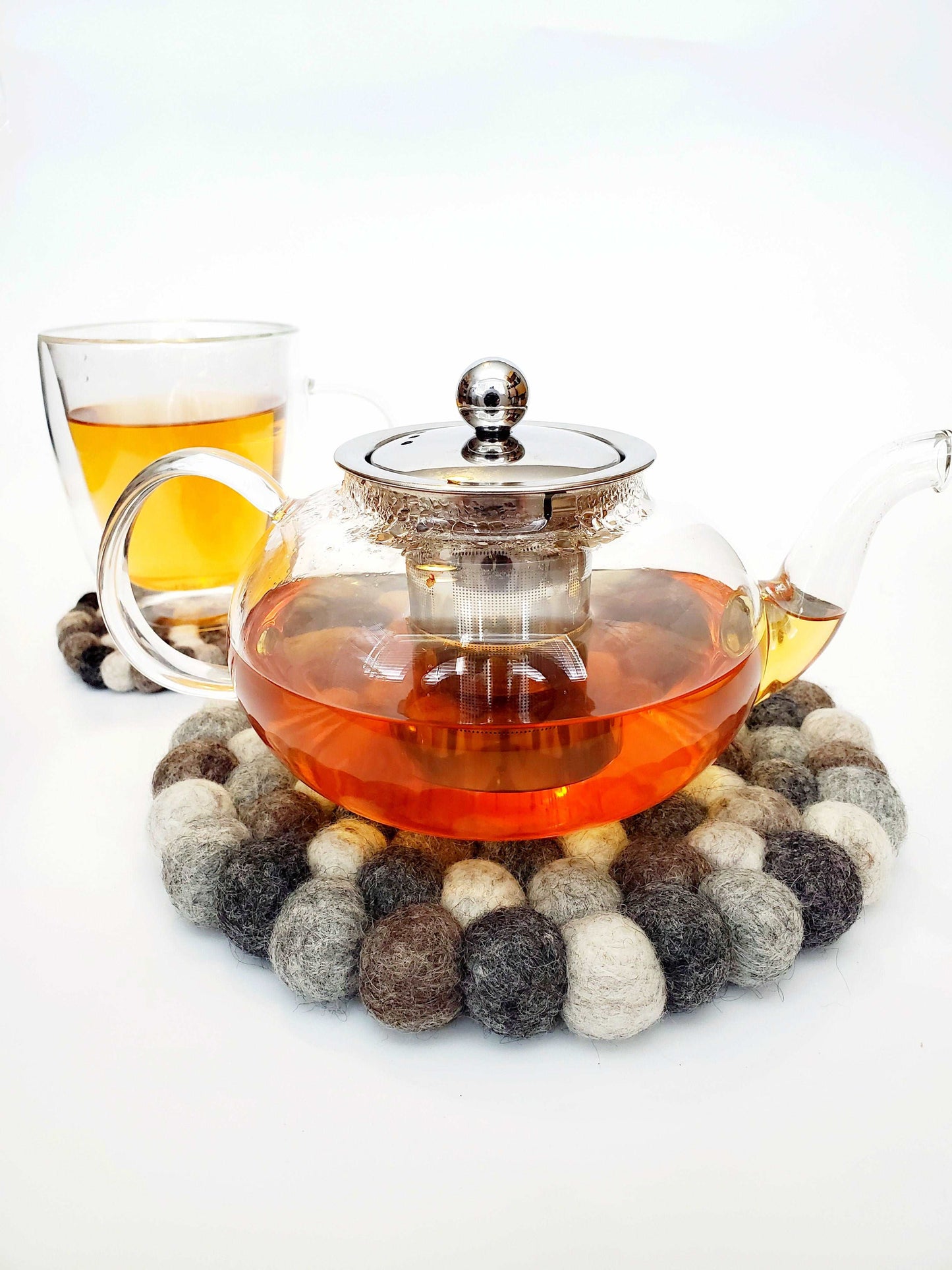 This Global Groove Life, handmade, ethical, fair trade, eco-friendly, sustainable, grey, Pebble felt trivet was created by artisans in Kathmandu Nepal and will bring warmth and functionality to your table top.