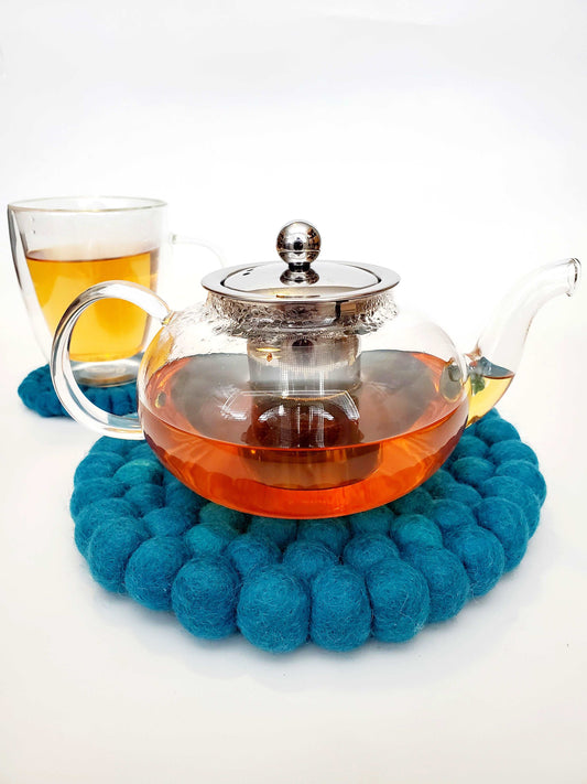 This Global Groove Life, handmade, ethical, fair trade, eco-friendly, sustainable,Teal felt trivet was created by artisans in Kathmandu Nepal and will bring warmth and functionality to your table top.