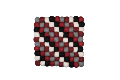 This Global Groove Life, handmade, ethical, fair trade, eco-friendly, sustainable, black, grey, red & white 100% New Zealand wool felt trivet was created by artisans in Kathmandu Nepal and will bring colorful warmth and functionality to your table top.