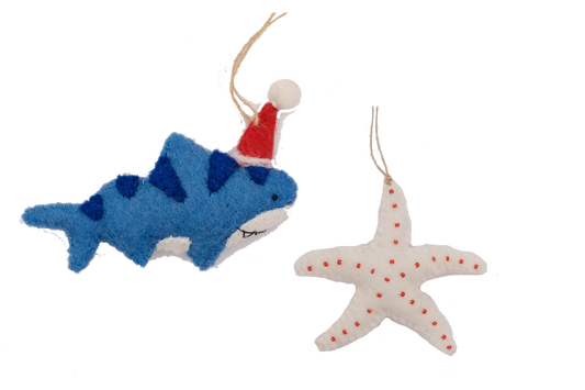 This Global Groove Life, handmade, ethical, fair trade, eco-friendly, sustainable, blue, white and red, felt Shark Santa with Starfish ornament set was created by artisans in Kathmandu Nepal and will be a beautiful addition to your Christmas tree this holiday season.