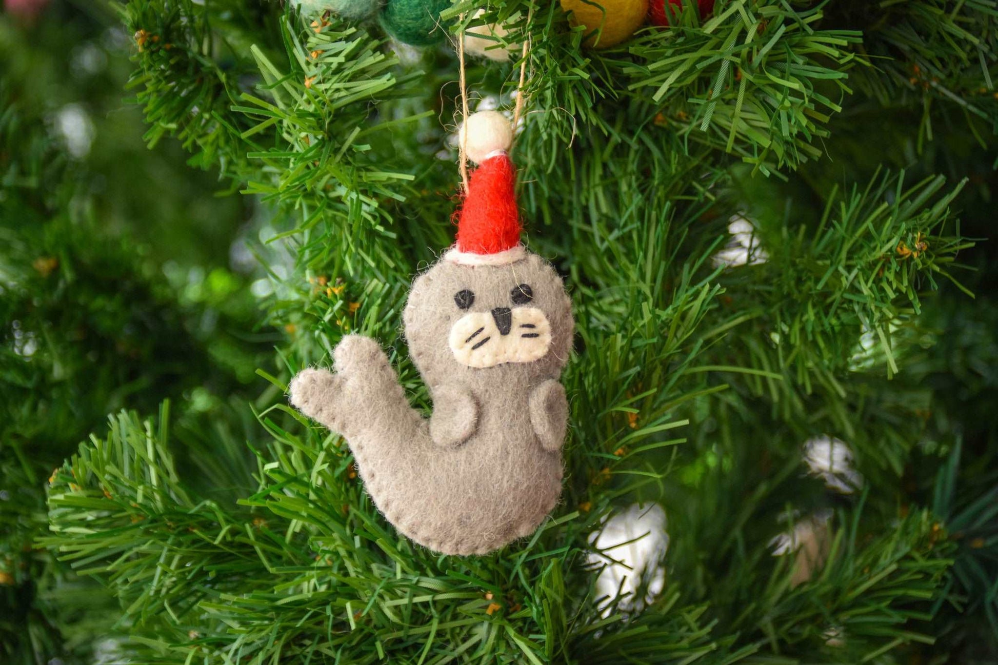 This Global Groove Life, handmade, ethical, fair trade, eco-friendly, sustainable, grey, white and red, felt Seal Santa with Starfish ornament set was created by artisans in Kathmandu Nepal and will be a beautiful addition to your Christmas tree this holiday season.