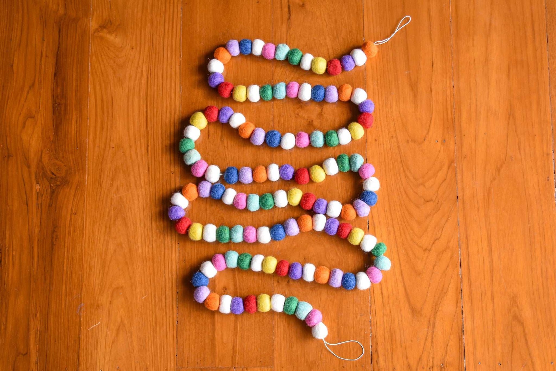 This Global Groove Life, handmade, ethical, fair trade, eco-friendly, sustainable, felt, red, white, pink, green, blue, purple, and orange felt Gumdrop garland ,was created by artisans in Kathmandu Nepal and will bring beautiful color, warmth and fun to your home.