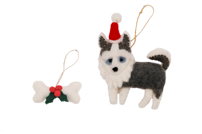 This Global Groove Life, handmade, ethical, fair trade, eco-friendly, sustainable, white and grey Husky Sant Dog with white, green and red bone treat ornament set was created by artisans in Kathmandu Nepal and will be a beautiful addition to your Christmas tree this holiday season.